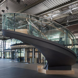 Design stairs featuring glass railings at Daimler in Sindelfingen | Stair railings | MetallArt Treppen